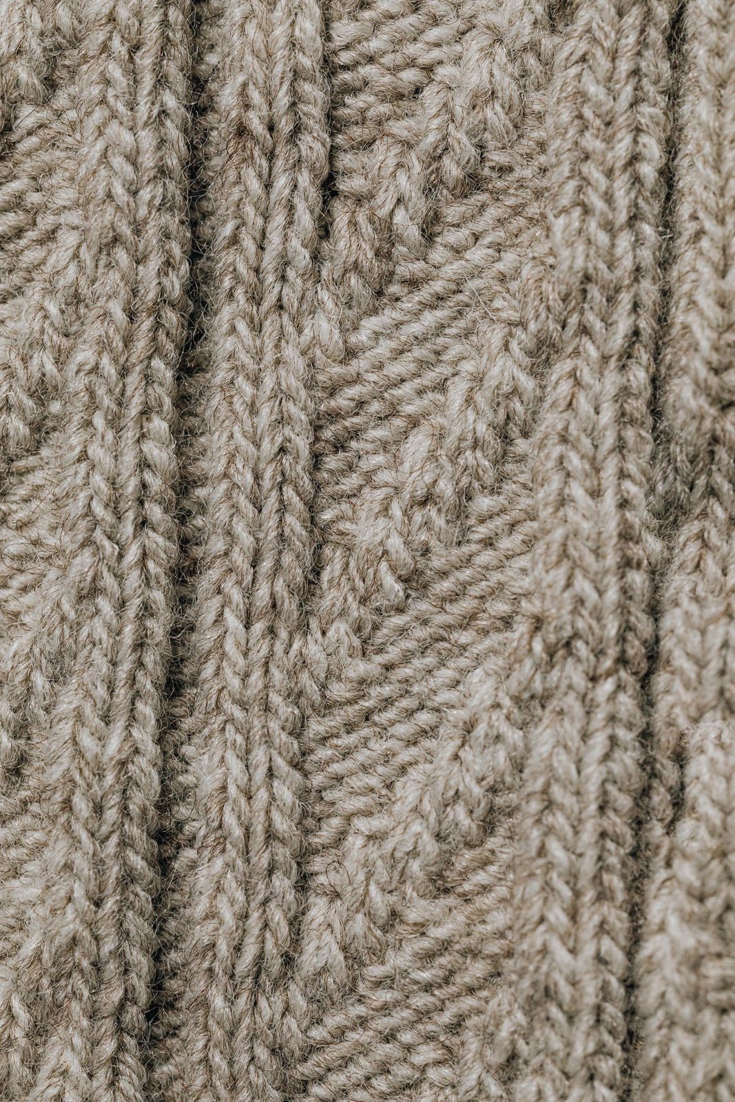 Close detail of a cable knit in undyed lambswool